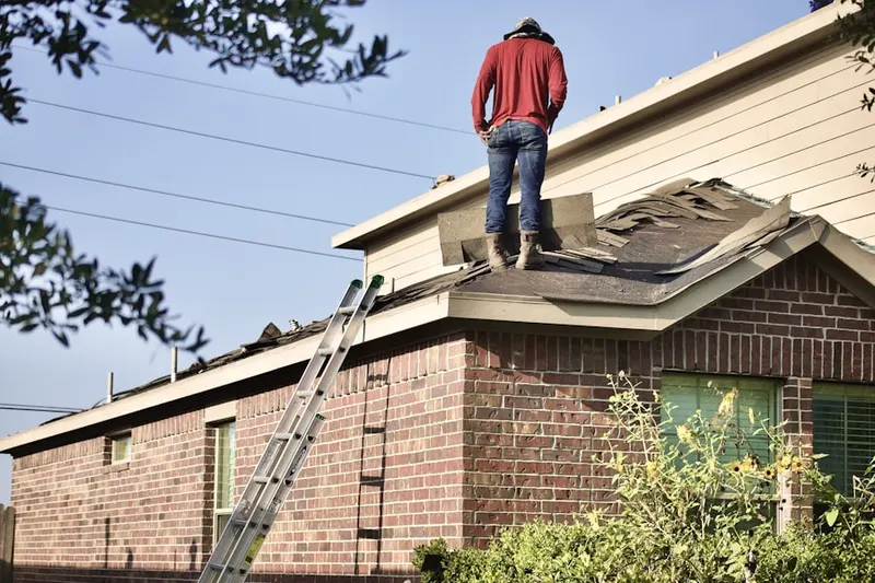 Professional roofer working on a residential roof in New Kingman-Butler